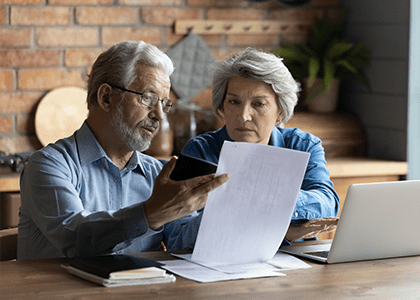 Couple reviewing financial paperwork