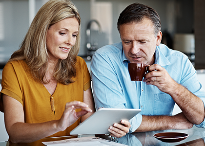 Couple looking at finances over coffee